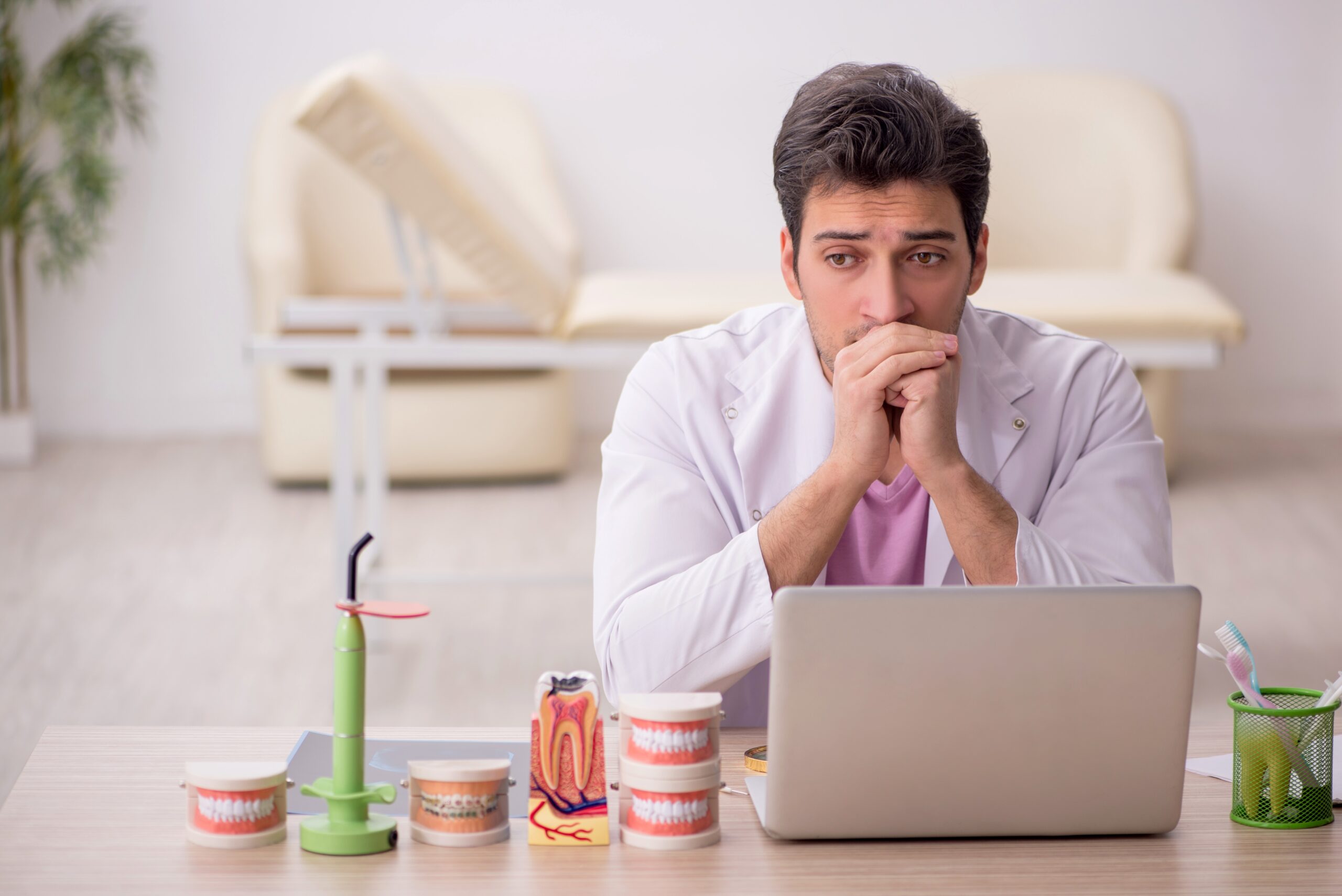 Young,Male,Dentist,Working,In,The,Clinic Worried dentist